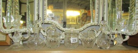 3 glass jam pots, 2 vinegar carafes and a pair of candlesticks.