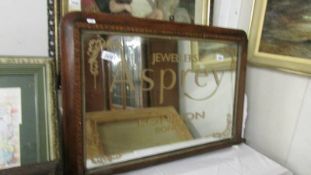 An inlaid overmantel mirror with later Asprey lettering.