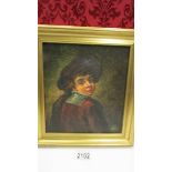 A gilt framed oil on canvas as a boy in the style of Rembrandt, initialled but indistinct.