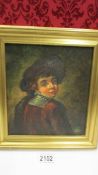 A gilt framed oil on canvas as a boy in the style of Rembrandt, initialled but indistinct.