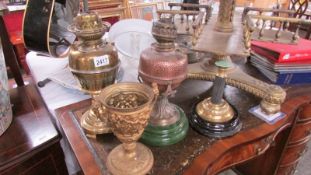 2 oil lamp bases with burners and 2 other lamp bases.