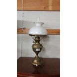 A brass oil lamp with shade.