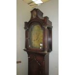 An oak cased 8 day long case clock with brass dial marked Bunnett.