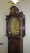 An oak cased 8 day long case clock with brass dial marked Bunnett.