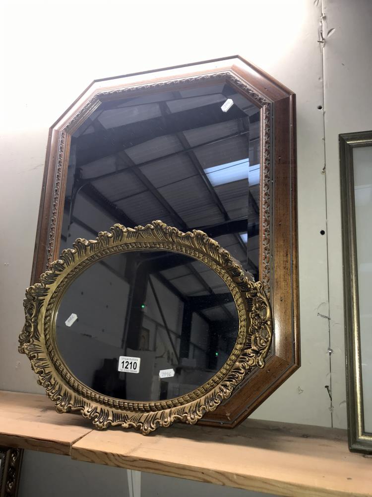 An octagon wooden framed mirror and an oval gilt framed mirror,