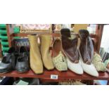 A shelf of vintage boots and shoes,