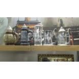 3 glass beer steins and 2 ceramic beer steins.