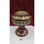 A North African pearl inlaid lidded wooden box.