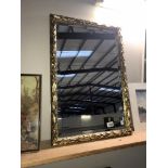 An ornate gilt framed mirror 72cm x 49cm approx.