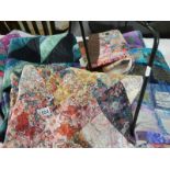A collection of patchwork quilted squares and a cushion cover