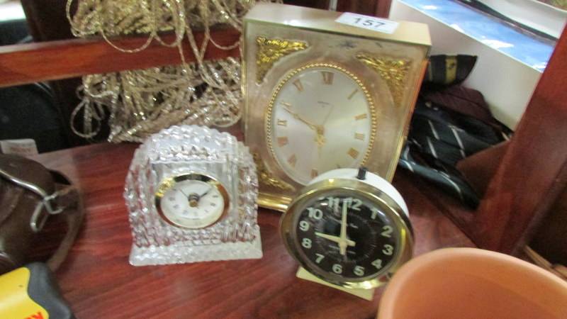 A glass clock and 2 others.