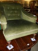 A green fabric covered nursing chair.
