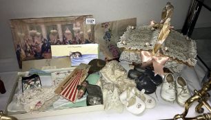 A quantity of interesting items including vintage babies shoes, linen, small wicker basket,