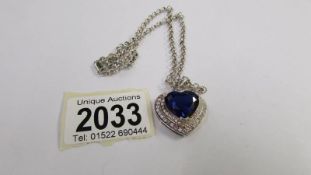 A heart pendant/chain in silver with blue and white stones, ideal for valentines day.