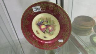An Aynsley plate hand decorated with fruit.