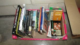 A box of books on cars and travel etc.