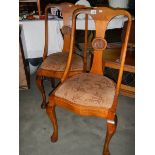 A pair of Edwardian dining chairs on Queen Anne legs