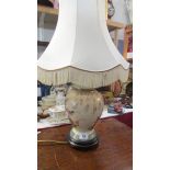 A ceramic table lamp with shade.