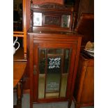 An Edwardian mahogany bevel mirrored cabinet with 'Sage Millinery Chicago' (later added