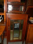 An Edwardian mahogany bevel mirrored cabinet with 'Sage Millinery Chicago' (later added