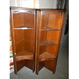 A pair of open corner cabinets.