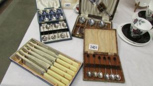 3 cased sets of 6 coffee spoons, a cased dessert spoon set and a set of knives.
