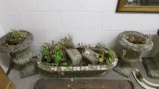 A pair of garden urns and an oblong planter.