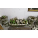 A pair of garden urns and an oblong planter.