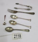 A quantity of silver spoons, silver fork and silver sugar tongs, 98 grams / 3.45 ounces.