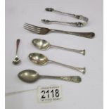 A quantity of silver spoons, silver fork and silver sugar tongs, 98 grams / 3.45 ounces.