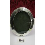 A hall marked London 1903 oval silver photograph frame in good condition.