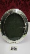 A hall marked London 1903 oval silver photograph frame in good condition.