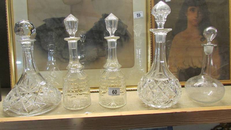 A pair of cut glass decanters and 3 others.