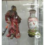 A Chinese figure and a Chinese lamp base.