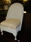 A lloyd loom style side chair with spring upholstered seat