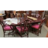 An oval mahogany extending dining table with one leaf together with a set of 6 shield back dining