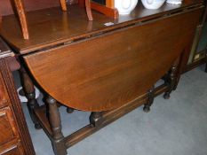 A large oak dropleaf gate leg table