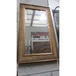 A gilt framed bevel edged mirror.