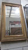 A gilt framed bevel edged mirror.