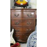 A small four drawer chest.