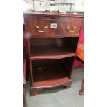 A small single drawer bookcase.