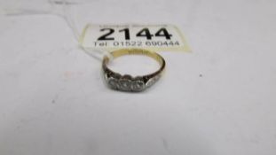 A three stone 20 pt 18ct yellow gold diamond ring, size N, total 2.5 g.
