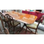 A mahogany extending dining table and 6 chairs.