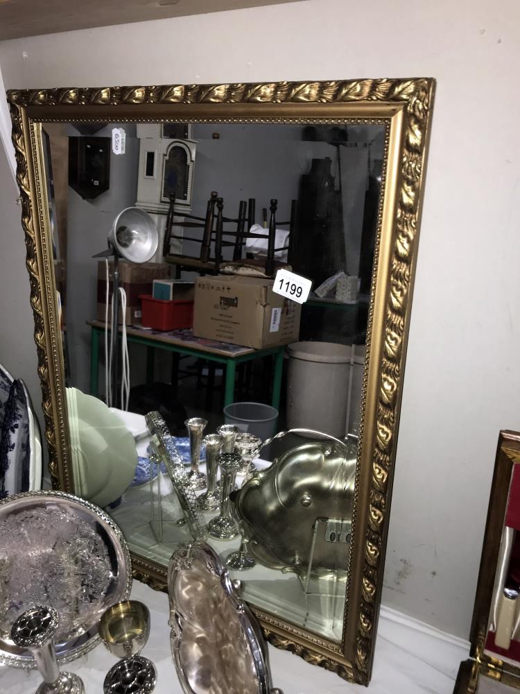 An ornate gilt framed mirror Size 52.5cm x 68cm approx.