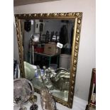 An ornate gilt framed mirror Size 52.5cm x 68cm approx.