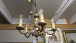 An Italian Capo Di Monte brass and floral porcelain chandelier.