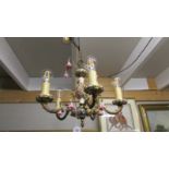 An Italian Capo Di Monte brass and floral porcelain chandelier.