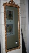 A gilt framed oblong mirror.