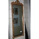 A gilt framed oblong mirror.