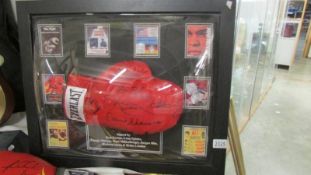 A framed and glazed signed boxing glove with certificate.